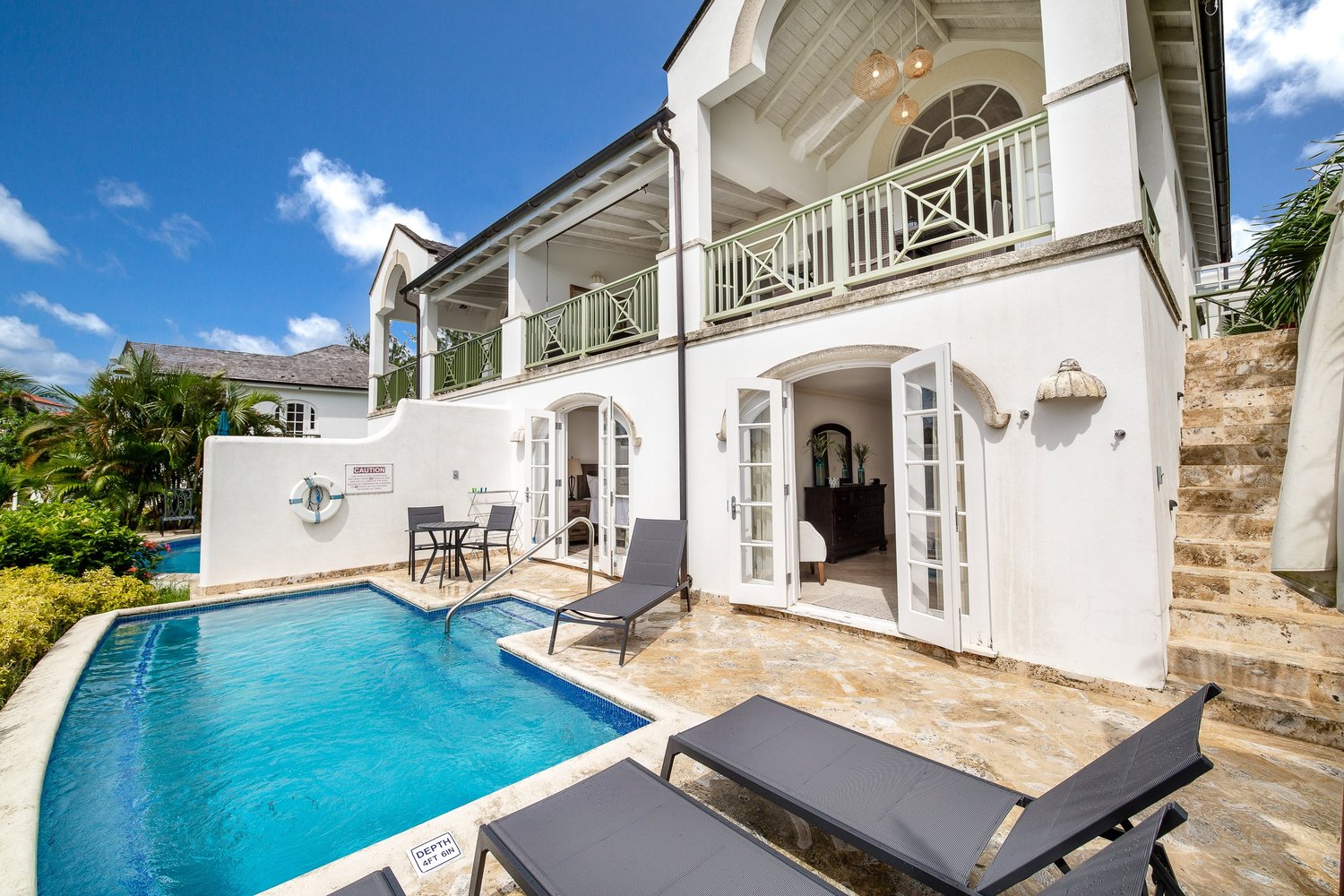 The white villa overlooking its private blue pool